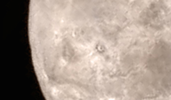 Illustration for article titled Charon Poses a Geomorphic Riddle: How do You Make a Mountain in a Moat?